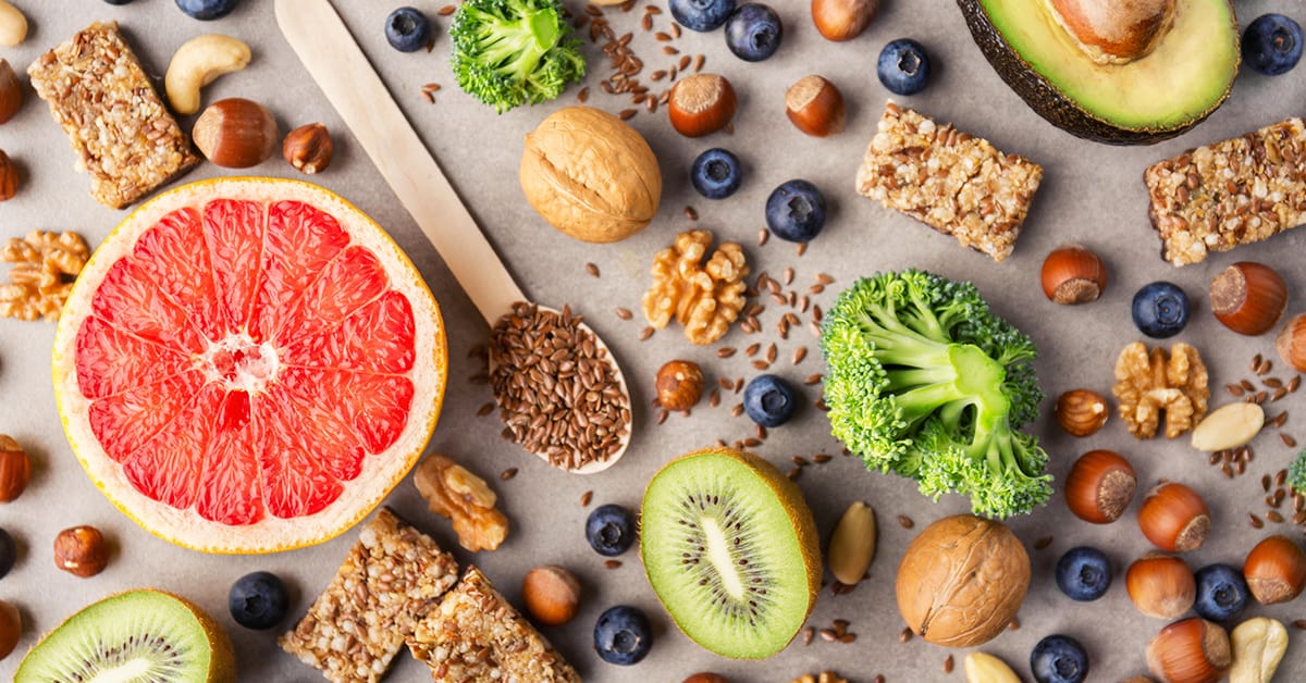 Concept of healthy food on grey background. Different fruits and healthy snacks. Top View with copy space.