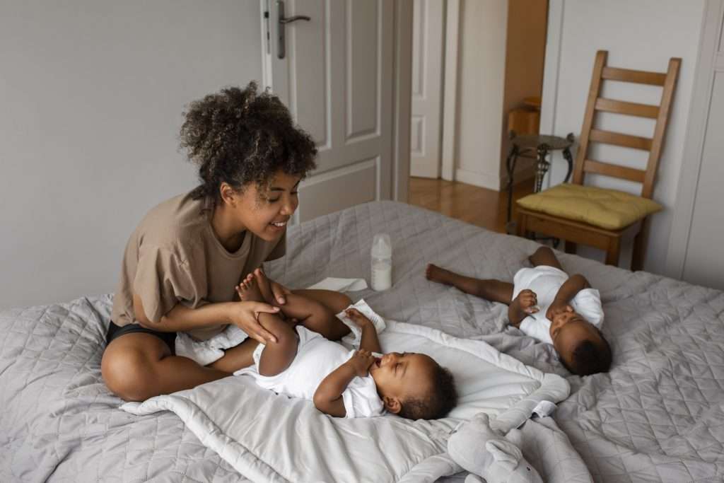 side-view-smiley-mother-with-baby