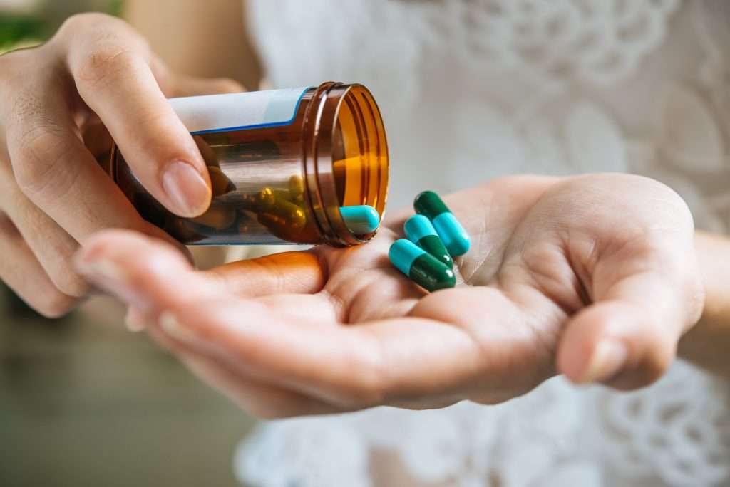 Woman's hand and pills